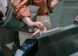 close up of woman sliding the card in a subway terminal