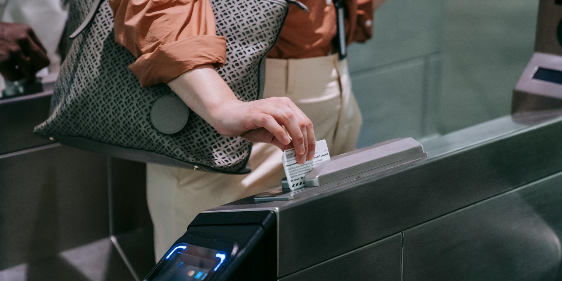 close up of woman sliding the card in a subway terminal