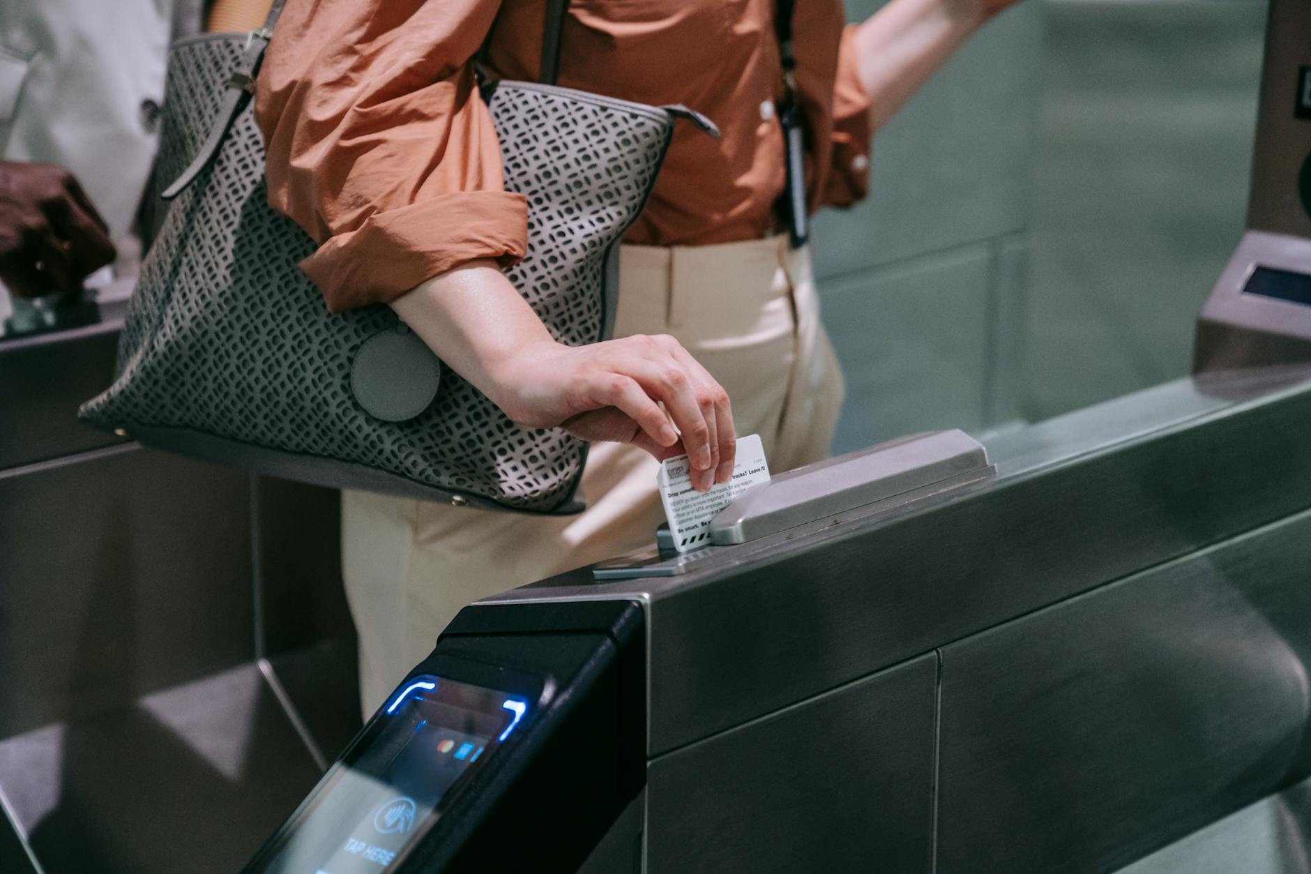pexels-photo-8554407 close up of woman sliding the card in a subway terminal